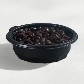A dish of flavorful, seasoned black beans.