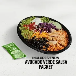 A Cantina Chicken Bowl filled with seasoned chicken, rice, beans, fresh vegetables, and a drizzle of creamy sauce.