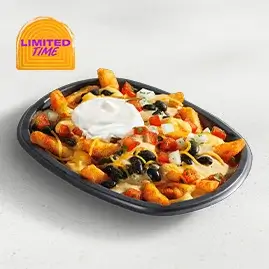 A plate of Jalapeño Ranch Nacho Fries Veggie loaded with seasoned fries, nacho cheese, black beans, and a drizzle of creamy jalapeño ranch sauce.