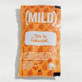 A packet of Taco Bell's Mild Sauce, featuring a smooth and tangy flavor with a mild heat.