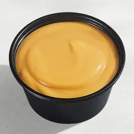 A container of Nacho Cheese Sauce, featuring a rich, creamy cheese flavor with a touch of spice, perfect for dipping or drizzling.