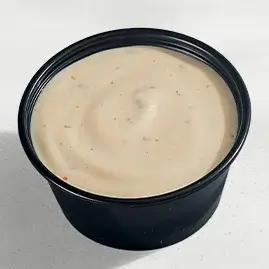A packet of Spicy Ranch, combining creamy ranch with a zesty kick of spice for a flavorful and tangy dip.