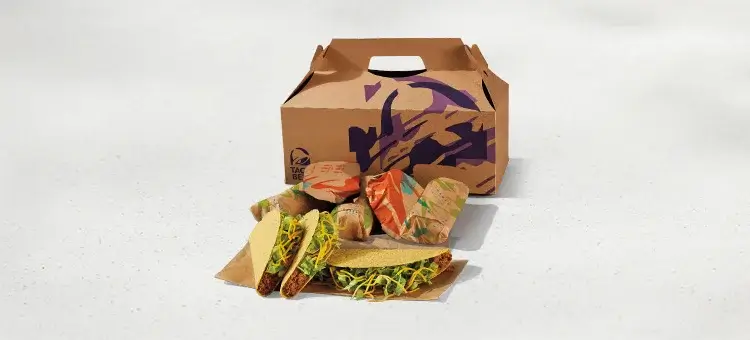 A tray of assorted tacos with beef, lettuce, tomatoes, and cheese, perfect for a party.